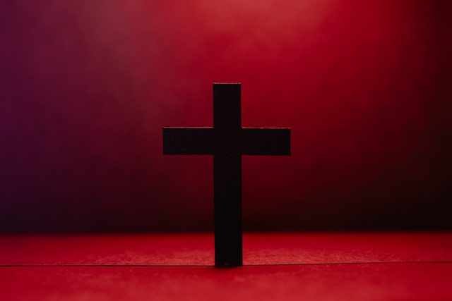 Black cross on red background